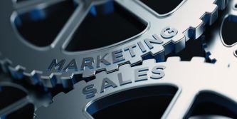 Metal cogs are turning. Marketing and sales words are written on the cogs. Horizontal composition with copy space.